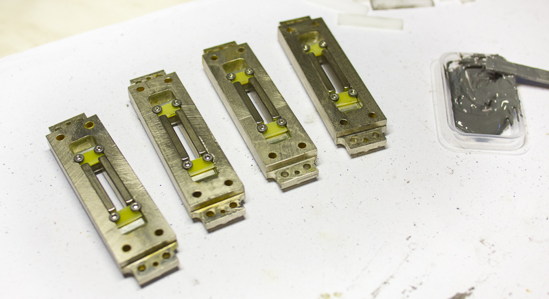 Four RE-323 Ribbon Microphone Motors being glued